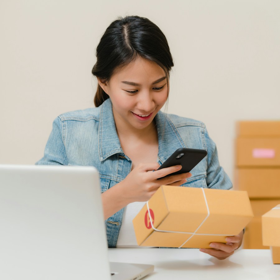 Beauty products being packed into a pink gift box